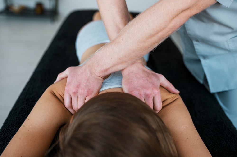 Osteopath Stockbridge A man providing osteopathy for Stockbridge patient.